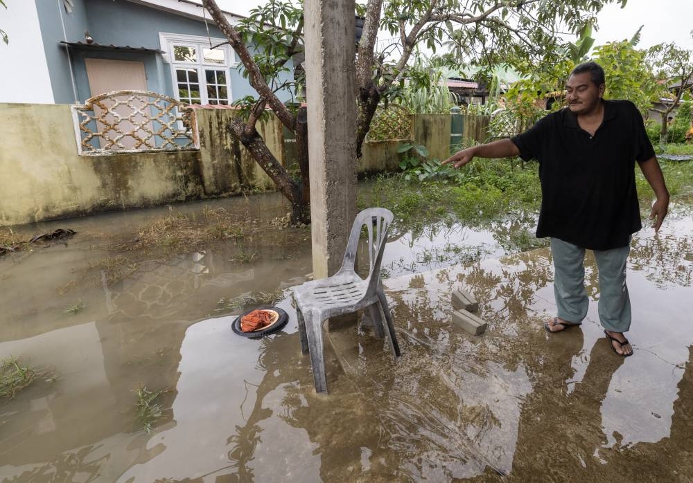Witness Wan Mohd Kamil Wan Daud, 52, who is a neighbor of the deceased victim, shows the spot where the third victim was electrocuted at his home in Kampung Bendang Surau near Morak, Tumpat, December 19, 2022. — Bernama pic 