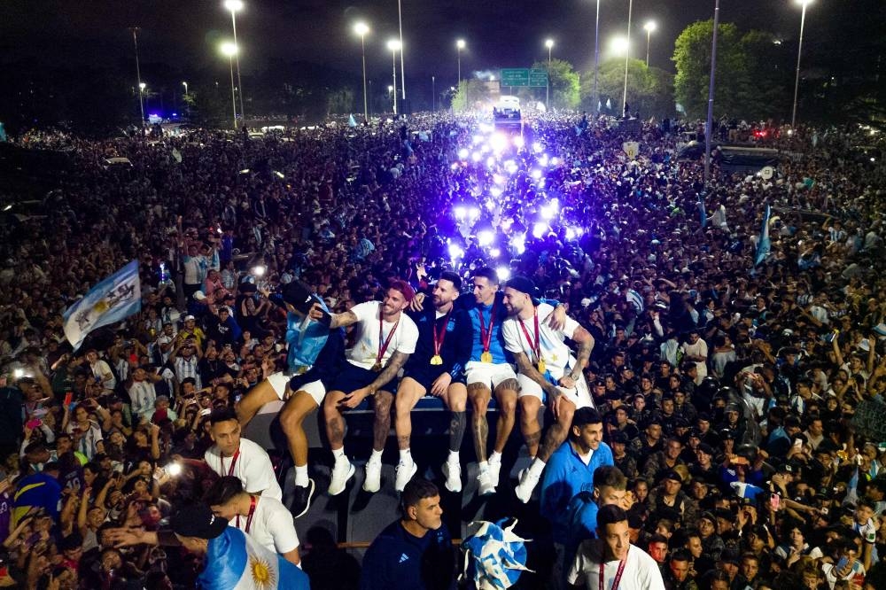 Argentina’s captain and forward Lionel Messi holds the Fifa World Cup Trophy on board a bus as he celebrates alongside teammates and supporters after winning the Qatar 2022 World Cup tournament in Ezeiza, Buenos Aires province, Argentina, December 20, 2022. — AFP pic 