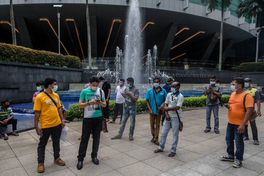 Foreign workers are seen at the KLCC vaccination centre to receive their Covid-19 jab July 29, 2021. — Picture by Firdaus Latif