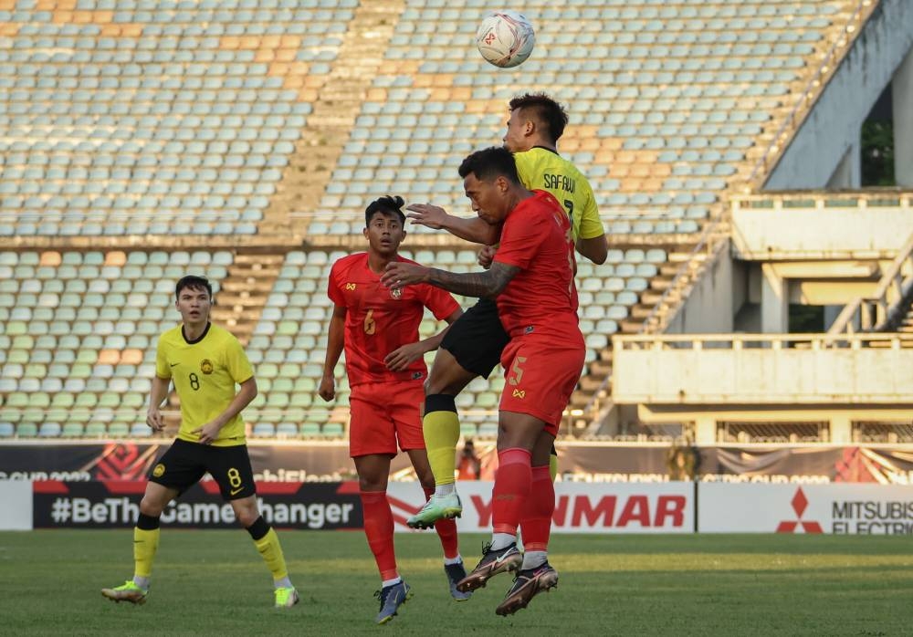 Muhammad Safawi in action with Myanmar players during the Asean Football Federation (AFF) Cup 2022 Group B match at Thuwunna Stadium in Yangon, December 21, 2022. — Bernama pic 