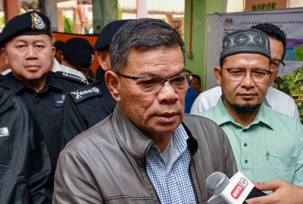 Home Minister Datuk Seri Saifuddin Nasution Ismail speaks to the media after visiting flood victims at a relief centre (PPS) in Alor Pasir, Kelantan, December 22, 2022. — Bernama pic 