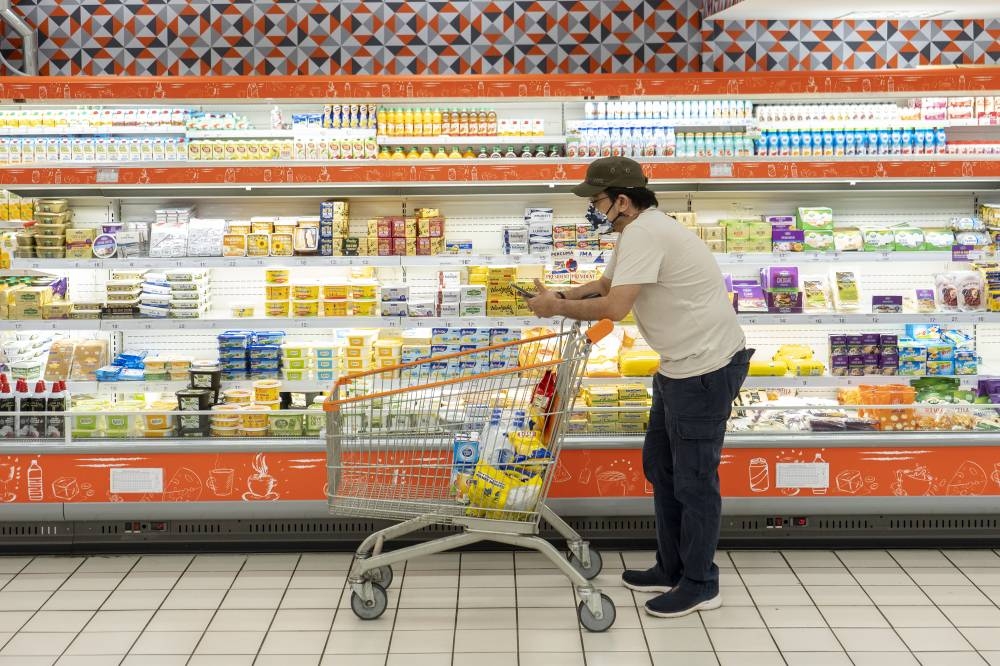 A customer buying a groceries at a supermarket in Putrajaya October 4, 2022. — Picture by Shafwan Zaidon