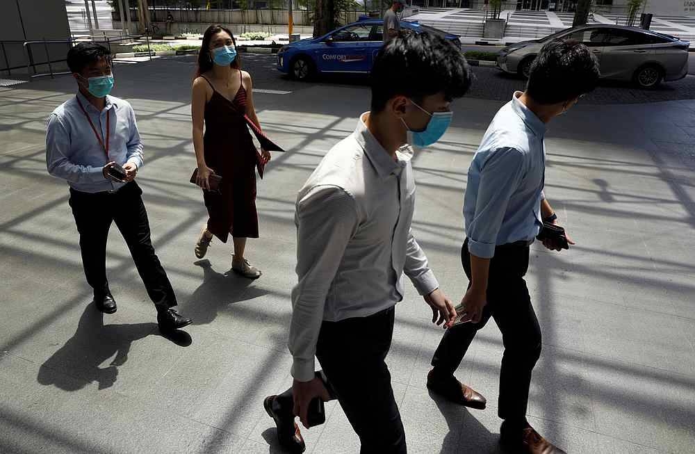 Office workers wearing face masks take their lunch break at the central business district amid the Covid-19 outbreak in Singapore June 2, 2020. — Reuters pic