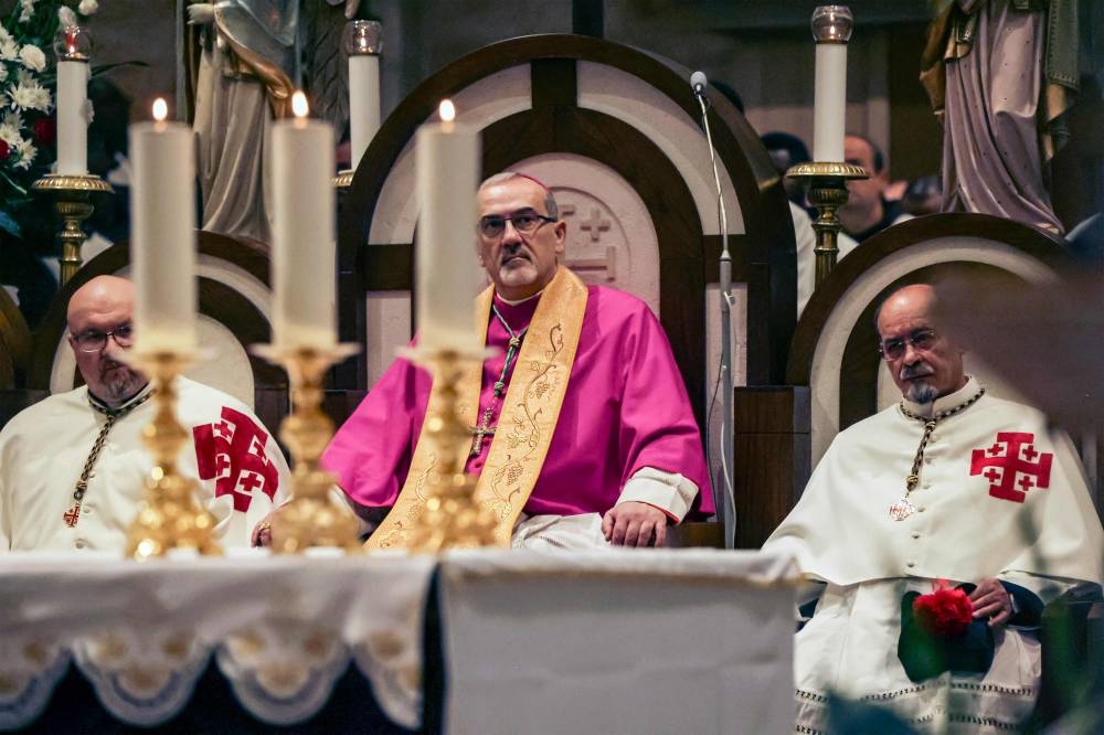 Latin Patriarch of Jerusalem Pierbattista Pizzaballa (centre) attends Christmas service at the Church of the Nativity in the biblical city of Bethlehem in the occupied West Bank on Christmas eve on December 24, 2022. — AFP pic