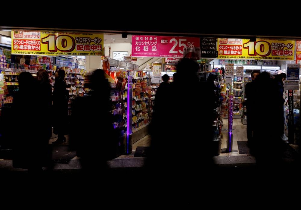 People walk as they make their way at a shopping district in Tokyo, Japan December 23, 2022. ― Reuters pic 