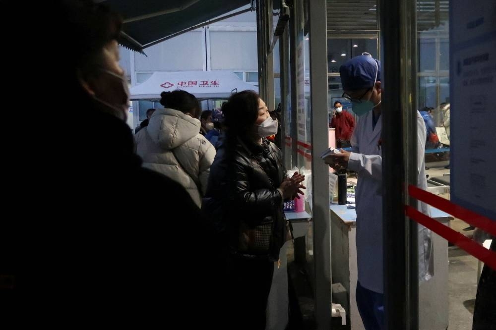 A family member consults a doctor outside an emergency department of a hospital in Chengdu, Sichuan province, China December 27, 2022. ― Reuters pic