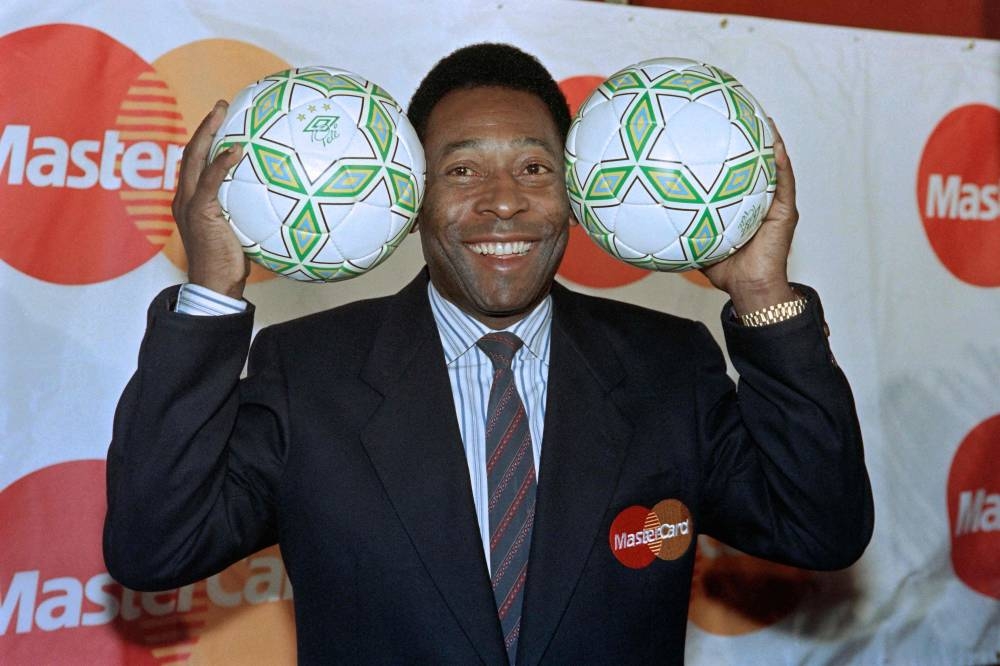 In this file photo taken on April 1, 1992 Pelé, holds footballs at an appearance in New York. — AFP pic