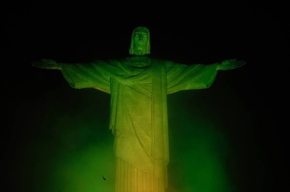 The Christ The Redeemer statue, on top of Corcovado mountain, is illuminated in green and yellow, the colours of the Brazilian national flag, in honour of Brazilian football legend Pele, in Rio de Janeiro, Brazil on December 29, 2022, just hours after his passing at a Sao Paulo hospital. — AFP pic