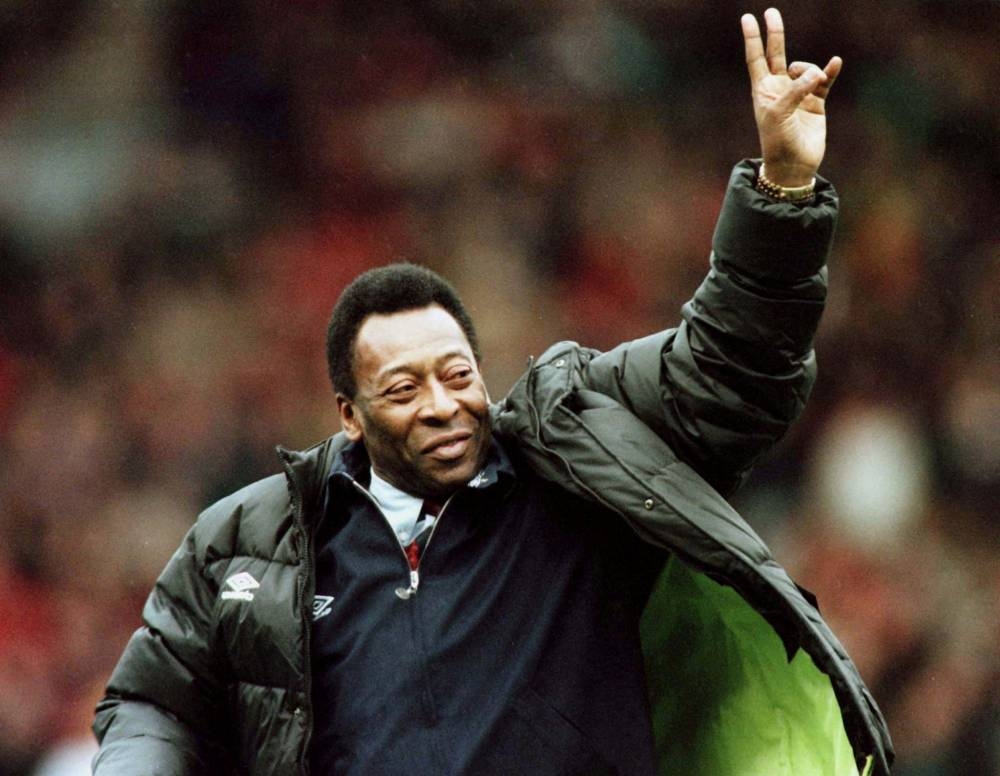 Brazilian football legend Pele greets the crowd at the Manchester United versus Liverpool match during the half time interval in Manchester, Britain, April 10, 1998. — Reuters file pic