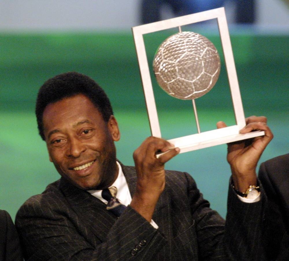 In this file photo taken on December 11, 2000 Brazilian former football player Pele holds his Fifa grand prix of 