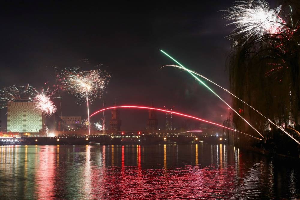 Fireworks explode over the Oberbaumbruecke bridge, as people celebrate the start of the new year, in Berlin, Germany, January 1, 2023. — Reuters pic