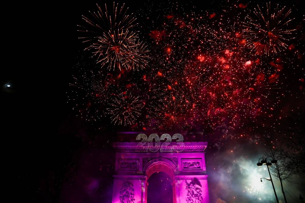 Fireworks illuminate the sky over the Arc de Triomphe during the New Year's celebrations on the Champs Elysees avenue in Paris, France, January 1, 2023. — Reuters pic