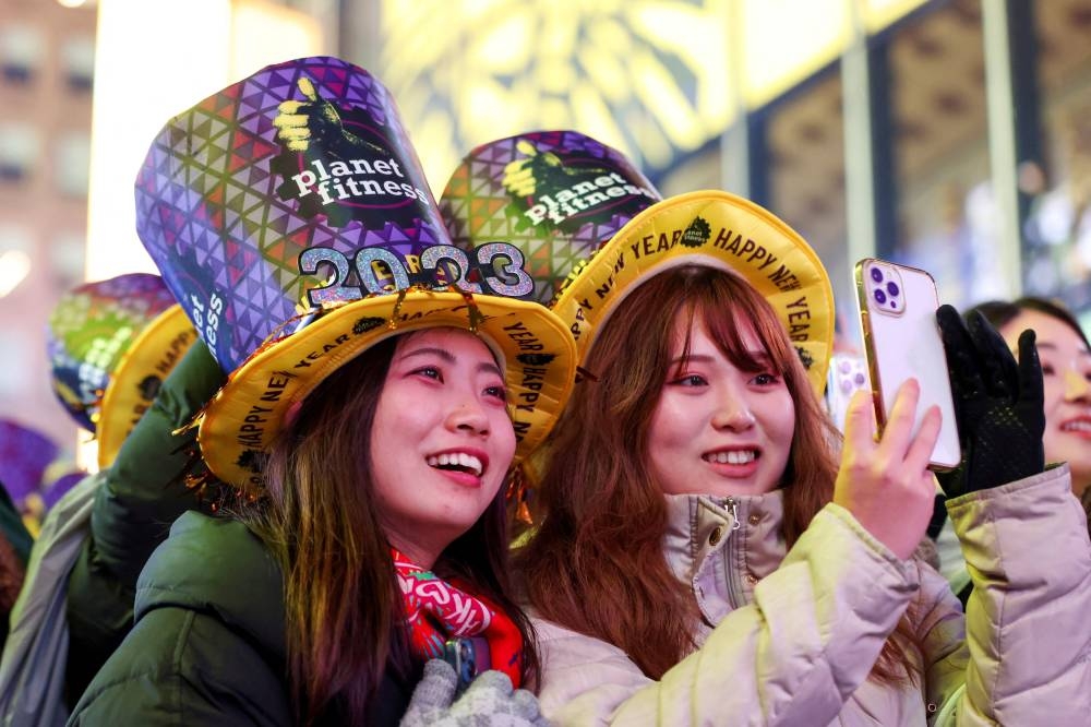 People gather in Times Square during the first New Year's Eve event without restrictions since the coronavirus disease (COVID-19) pandemic in the Manhattan borough of New York City, New York December 31, 2022. — Reuters pic