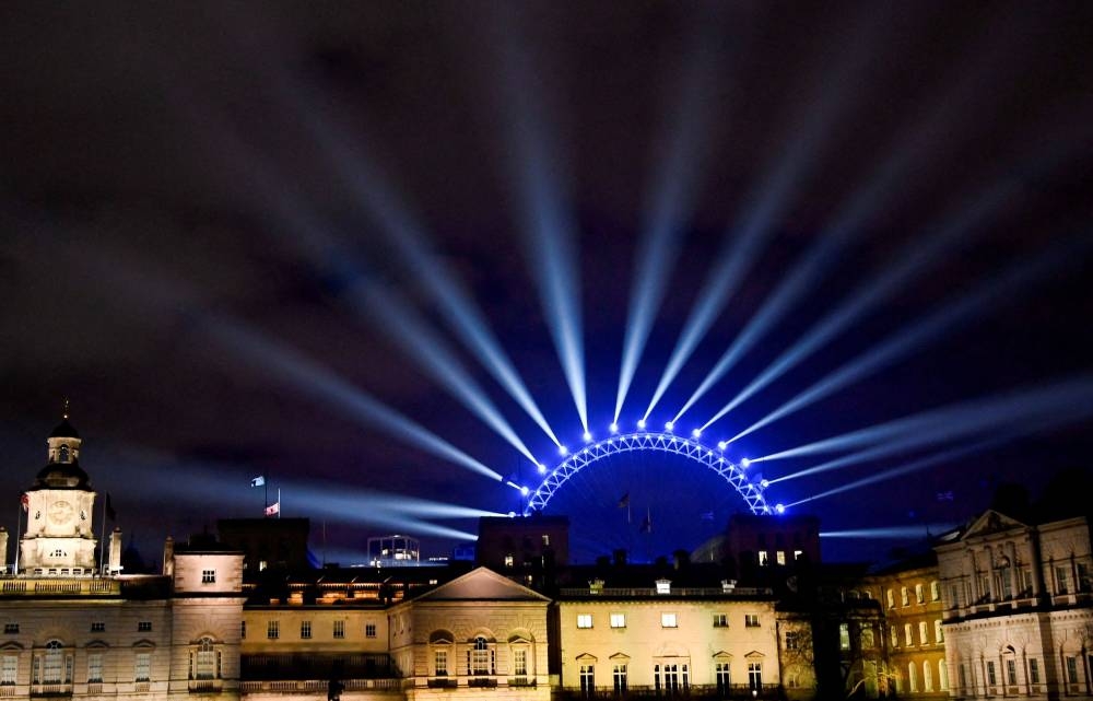 The London Eye is seen illuminated ahead of the New Year's Eve celebrations, in central London December 31, 2022. — Reuters pic