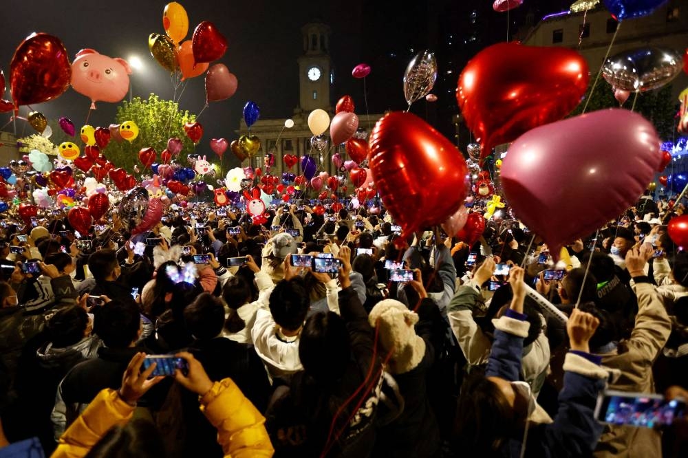 People release balloons as they gather to celebrate New Year's Eve, amid the coronavirus disease (COVID-19) outbreak, in Wuhan, Hubei province, China January 1, 2023. — Reuters pic