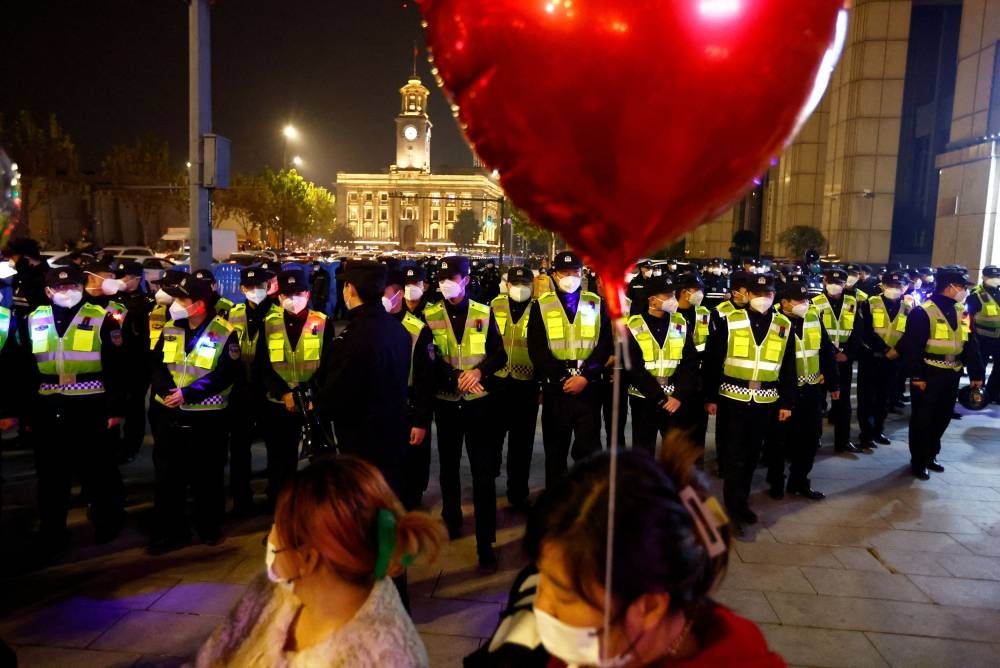 Police guard an area to avoid mass gatherings during New Year's Eve celebration, amid the coronavirus disease (COVID-19) outbreak, in Wuhan, Hubei province, China December 31, 2022. — Reuters pic