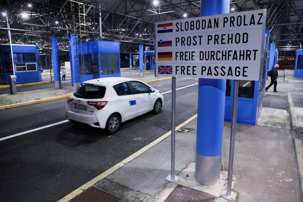 A vehicle passes by during the opening of the border cross as Croatia enters the EU's control-free Schengen Area, in Bregana, Croatia, January 1, 2023. — Reuters pic