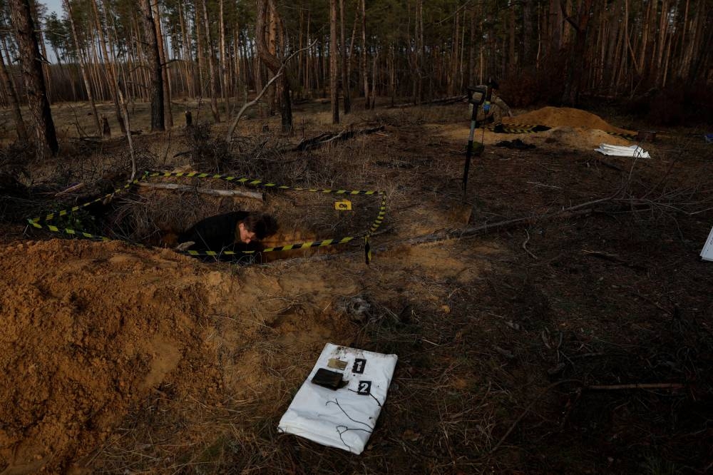 Artur Simeiko 26, exhumes the body of a fallen Ukrainian soldier with the humanitarian mission ‘Black Tulip’ which searches, exhumes, and retrieves bodies of soldiers, as Russia’s attack on Ukraine continues, in Yampil, Ukraine, January 2, 2023.. — Reuters pic