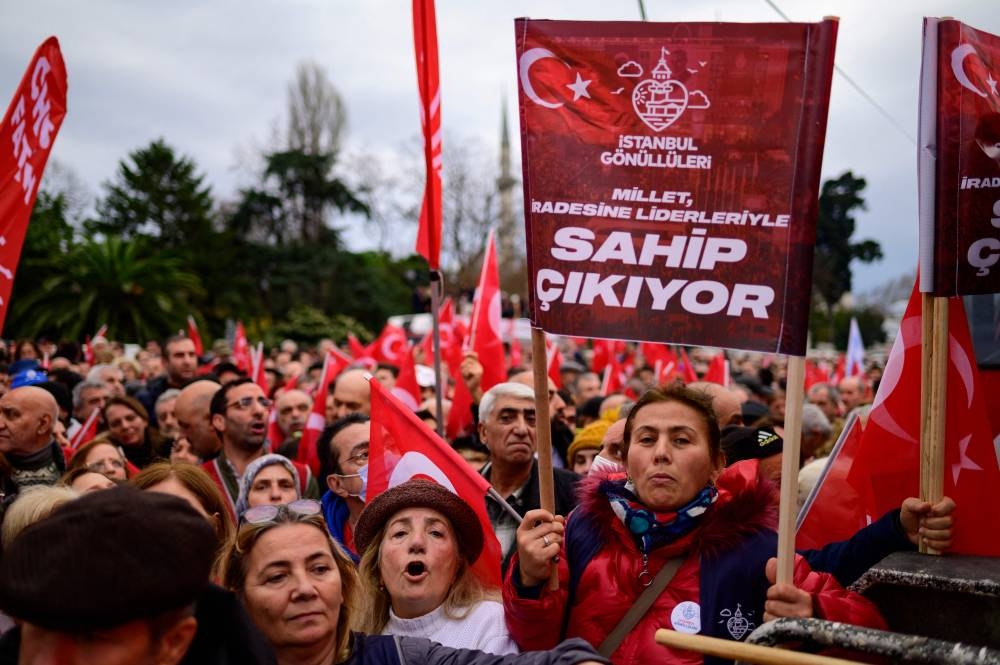 In this file photo taken on December 15, 2022 Supporters of Istanbul Mayor Ekrem Imamoglu wave national flags as they gather in front of the Istanbul Metropolitan Municipality during a protest in Istanbul, after a Turkish court sentenced him to more than two years jail and banned him from politics ahead of next year's presidential election. — AFP pic