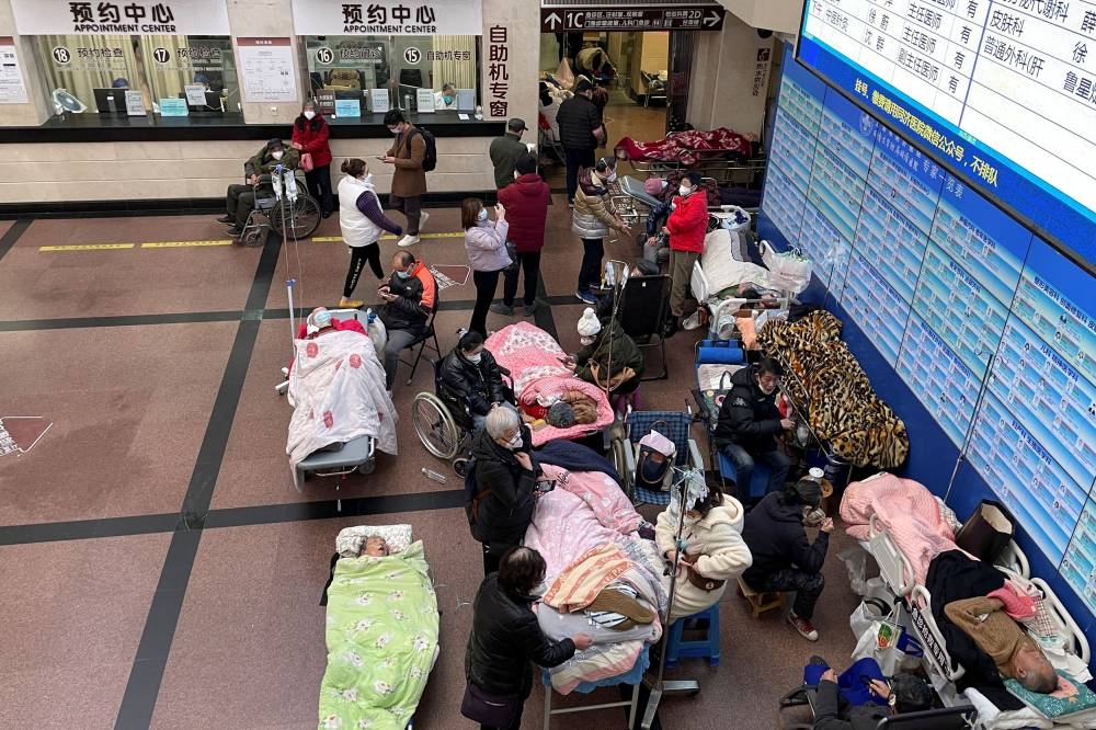 Patients lie on beds and stretchers in a hallway in the emergency department of a hospital, amid the coronavirus disease (Covid-19) outbreak in Shanghai, China January 4, 2023. — Reuters pic