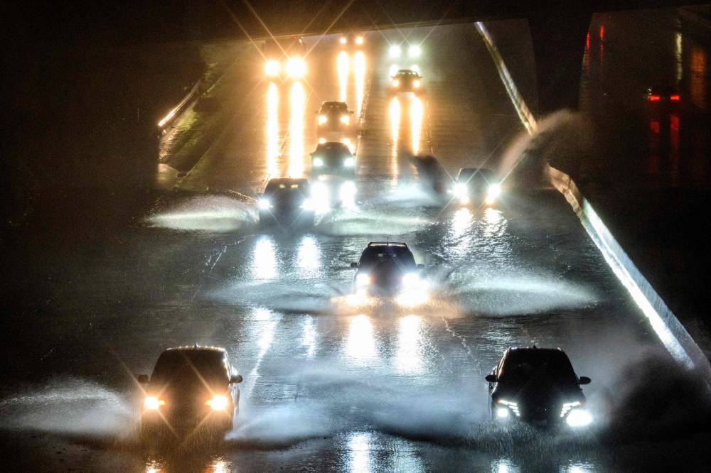 Drivers barrel into standing water on Interstate 101 in San Francisco, California on January 4, 2023. — AFP pic