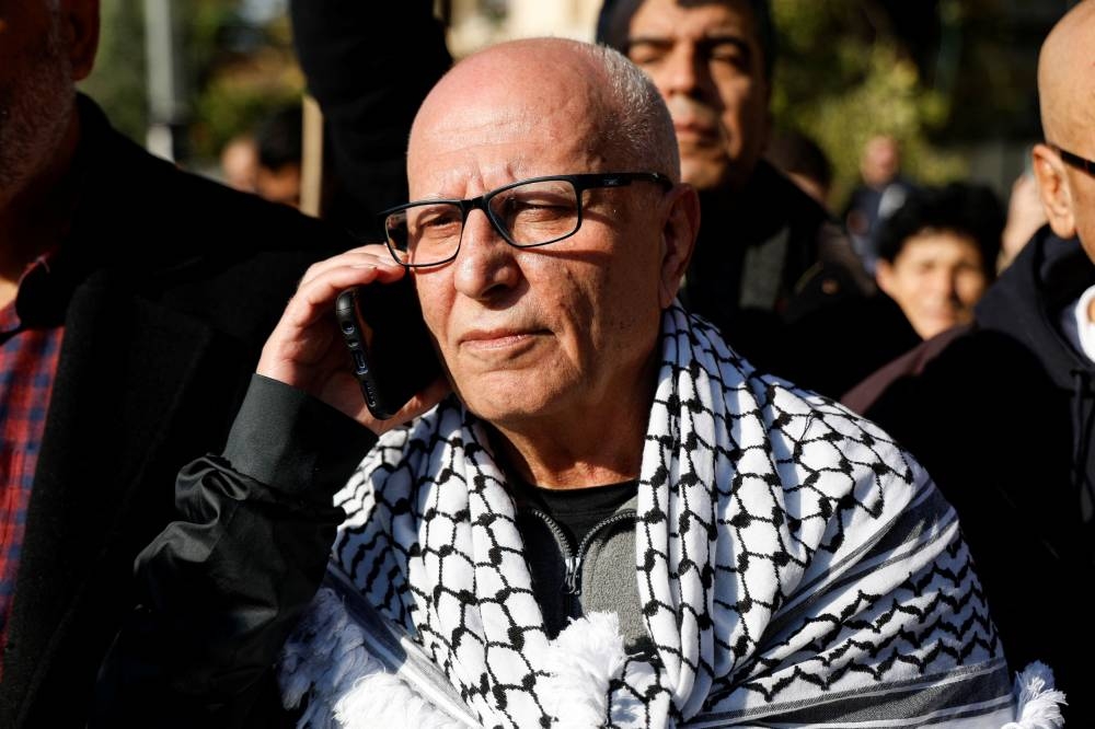 Longest serving Palestinian prisoner, Karim Younis, speaks on the phone as he is welcomed at his village, after he was freed from Israeli jail earlier today, in Ara, Israel January 5, 2023. — Reuters pic