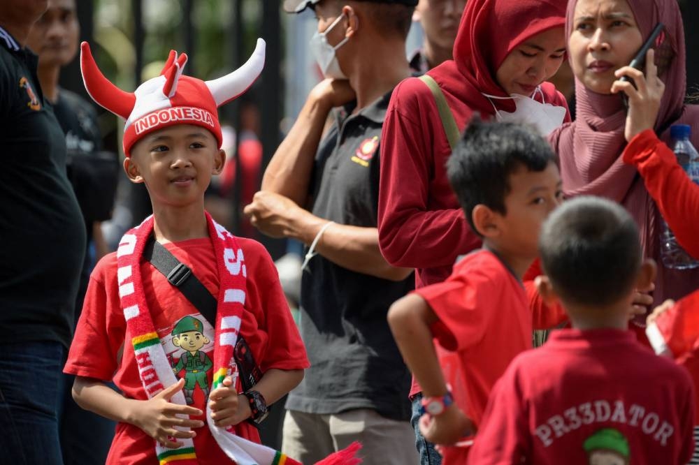 Indonesian football fans arrive to support their team before the AFF Mitsubishi Electric Cup 2022 football match between Indonesia and Vietnam at Gelora Bung Karno Stadium in Jakarta on January 6, 2023. — AFP pic