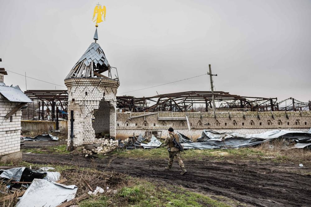 File photo of Tikhiy, 41-year-old, a Russian who joined the Freedom of Russia Legion to fight on the side of Ukraine, walking past a destroyed monastery in Dolyna, eastern Ukraine on December 26, 2022. — AFP pic