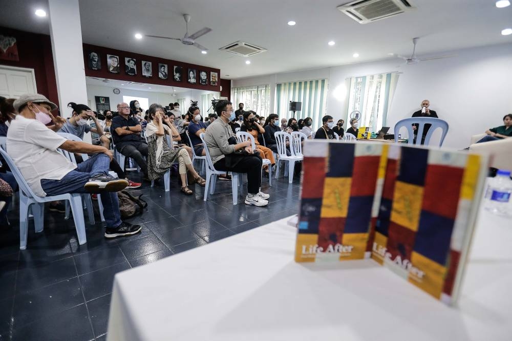Visitors listening as the panelists deliver their testimonies during the 'Life After: Oral Histories of the May 13 Incident' book launching at Gerakbudaya, Petaling Jaya, January 7, 2023. — Pix by Sayuti Zainudin
