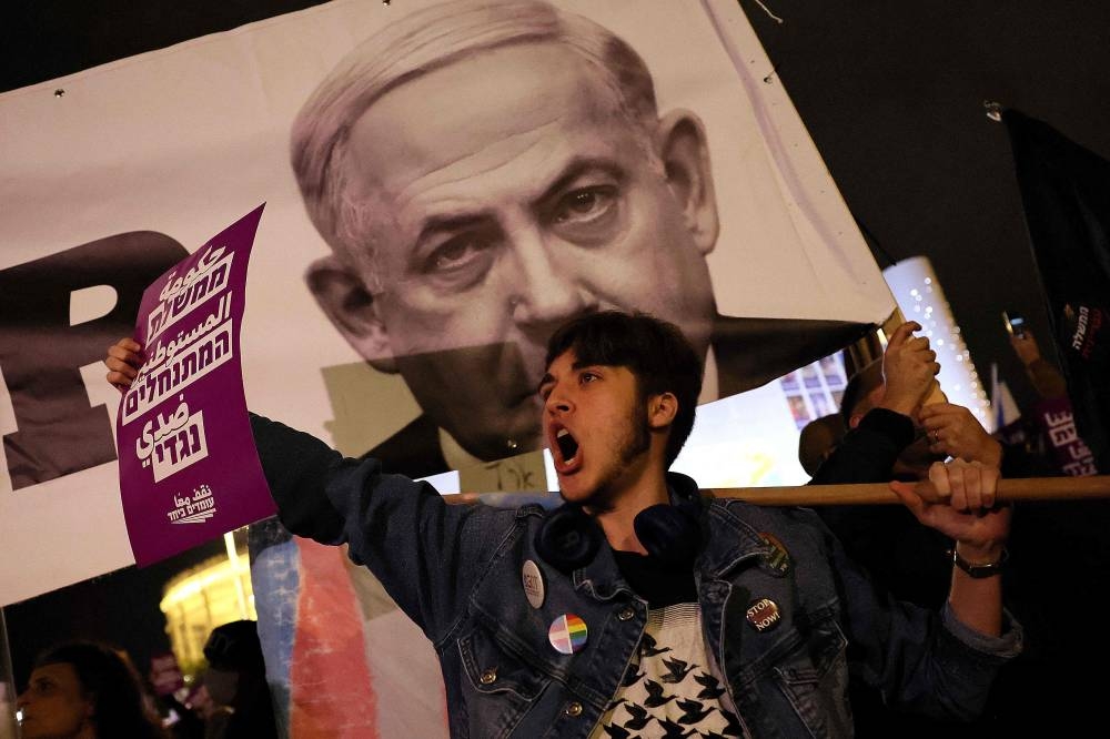 Israeli left wing protesters demonstrate against Israel's new hard-right government led by Prime Minister Benjamin Netanyahu, on January 7, 2023 in Tel Aviv. — AFP