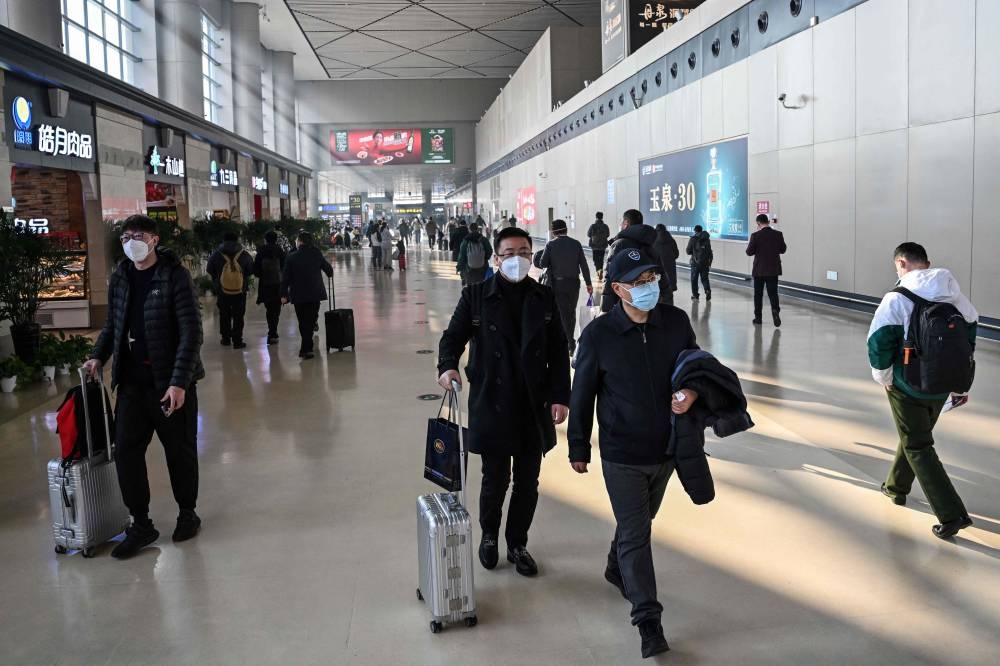 People are seen at Harbin Taiping International Airport in Harbin, in China's northeastern Heilongjiang province, on January 7, 2023. — AFP pic