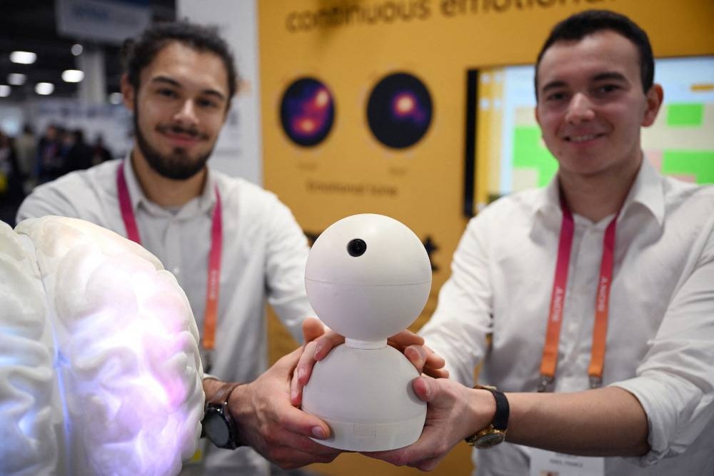 French tech start up co-founders Samuel Lerman (right) and Antony Perzo (left) display an Emobot, at Emobot’s booth at CES 2023 in Las Vegas, Nevada. — AFP pic