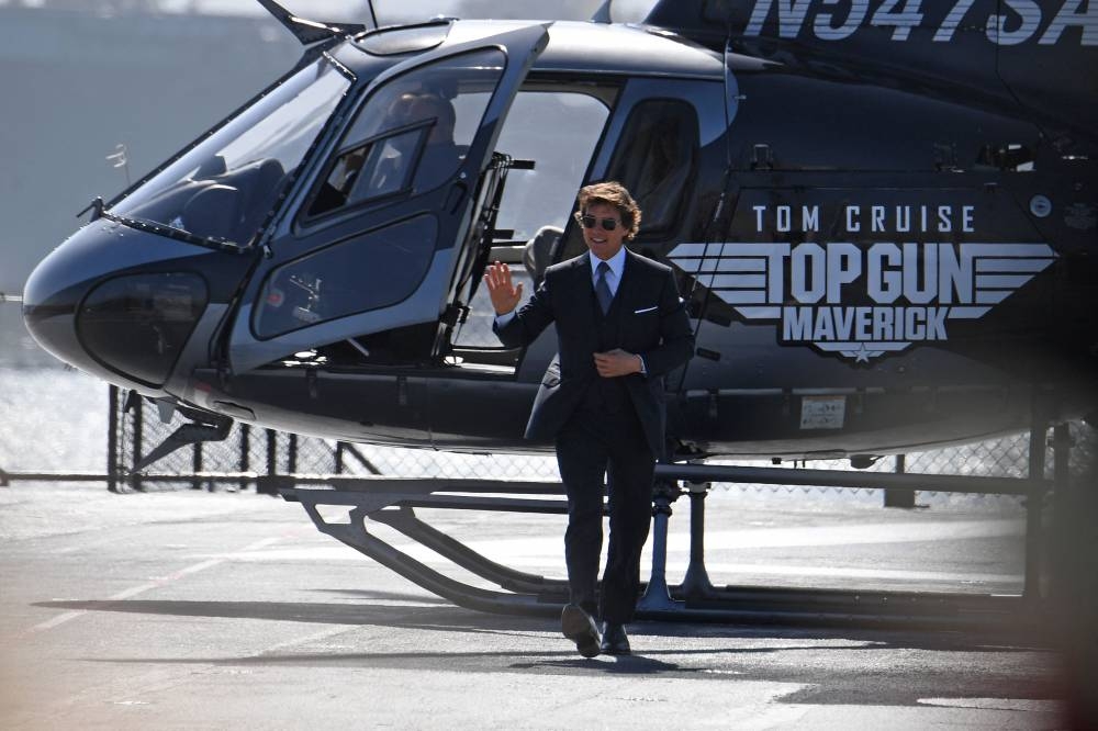 In this file photo taken on May 4, 2022 US actor Tom Cruise arrives in a helicopter to the world premiere of ‘Top Gun: Maverick!’ aboard the USS Midway in San Diego, California. — AFP pic