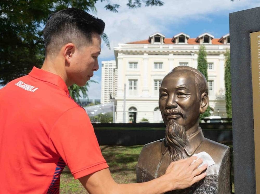 Duong Doan, a Vietnamese national living in Singapore, is pictured cleaning a bronze statue of the nation's former leader Ho Chi Minh located at Clarke Quay. — TODAY pic