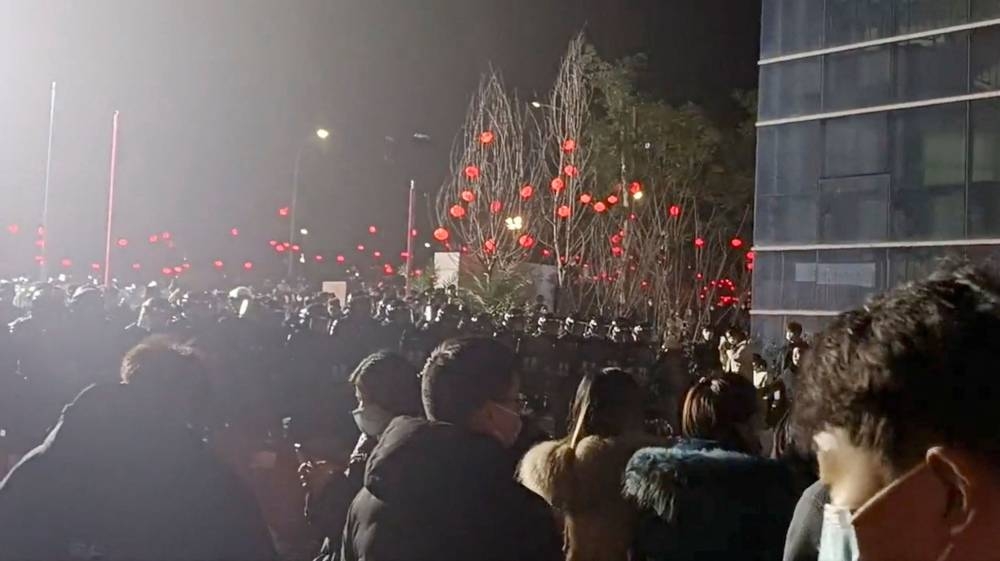 Police intervene at a protest at a factory, amid the coronavirus disease (Covid-19) outbreak in Chongqing, China in this screen grab from a video released on January 7, 2023 obtained by Reuters. — Screengrab via Reuters