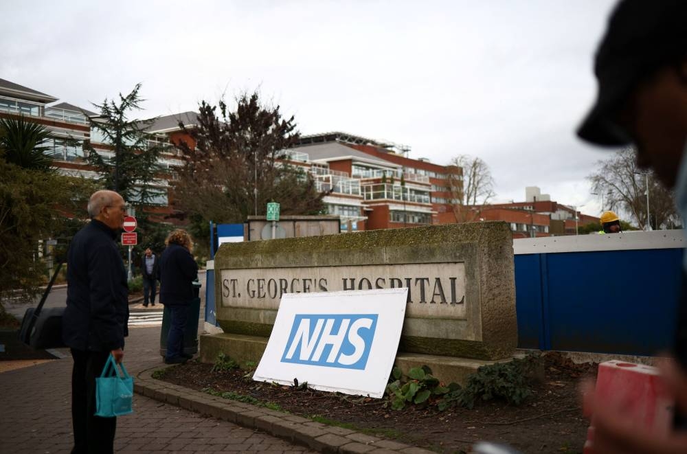 A person walks outside St George’s University Hospital, which has declared a critical incident due to bed shortages, in London, Britain, January 5, 2023. — Reuters pic