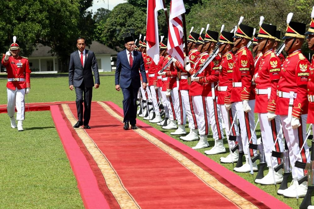 Prime Minister Datuk Seri Anwar Ibrahim is welcomed by Indonesian President Joko Widodo at the Bogor Presidential Palace in Bogor January 9, 2023. — Bernama pic