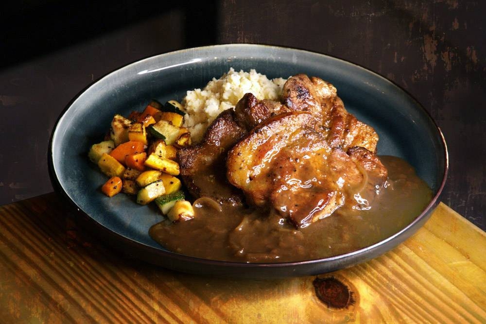 The grilled pork shoulder at Gluttony in Taman Desa, served with sautéed zucchini and buttery mash. – Pictures courtesy of Gluttony