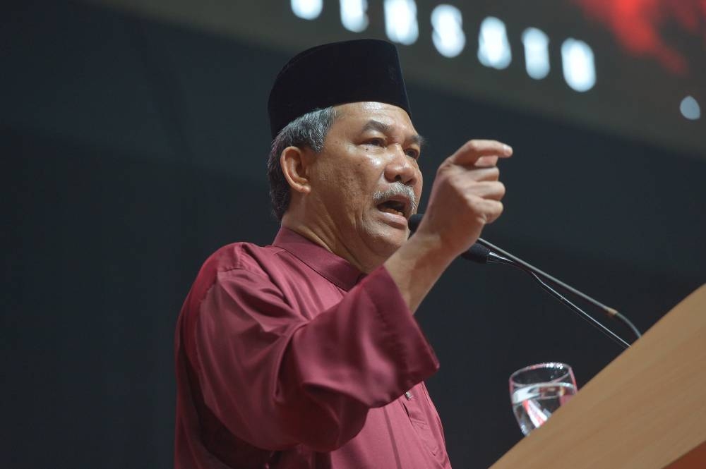 Datuk Seri Mohamad Hasan delivers his speech at the opening ceremony for Umno's general assembly at World Trade Centre Kuala Lumpur January 11, 2023. — Picture by Shafwan Zaidon