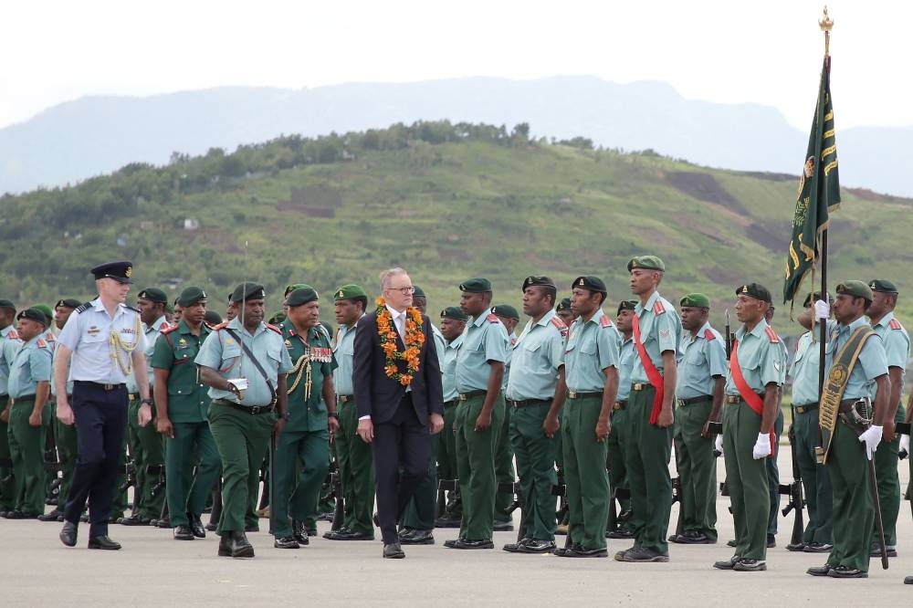 Australia’s Prime Minister Anthony Albanese (centre) inspects the guard of honour upon his arrival at Jacksons International Airport in Papua New Guinea’s capital Port Moresby on January 12, 2023.— AFP pic