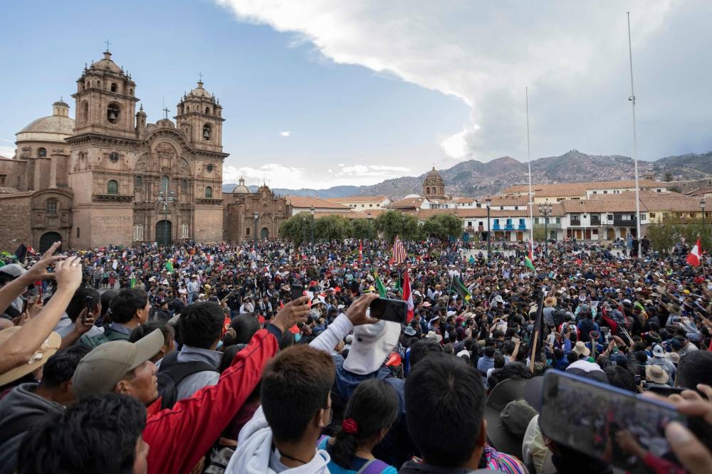 People take part in a demonstration and ceremony to pay a final tribute to Remo Candia, the leader of the Anta peasant community, at Cusco's main square in Peru, on January 12, 2023. — AFP pic