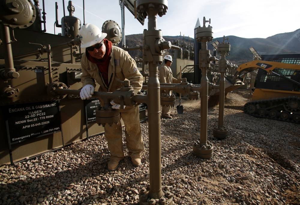File photo of workers puting the final touches on a natural gas well platform owned by Encana south of Parachute, Colorado, December 8, 2014. ― Reuters pic