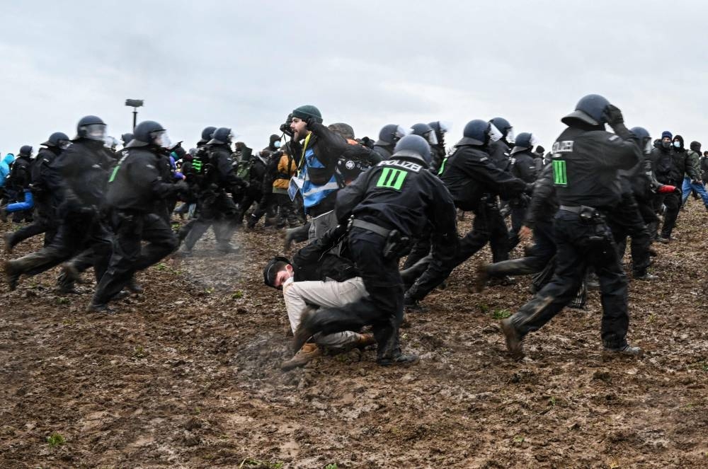 Police clashes with protesters during a large-scale protest to stop the demolition of the village Luetzerath to make way for an open-air coal mine extension on January 14, 2023. — AFP pic