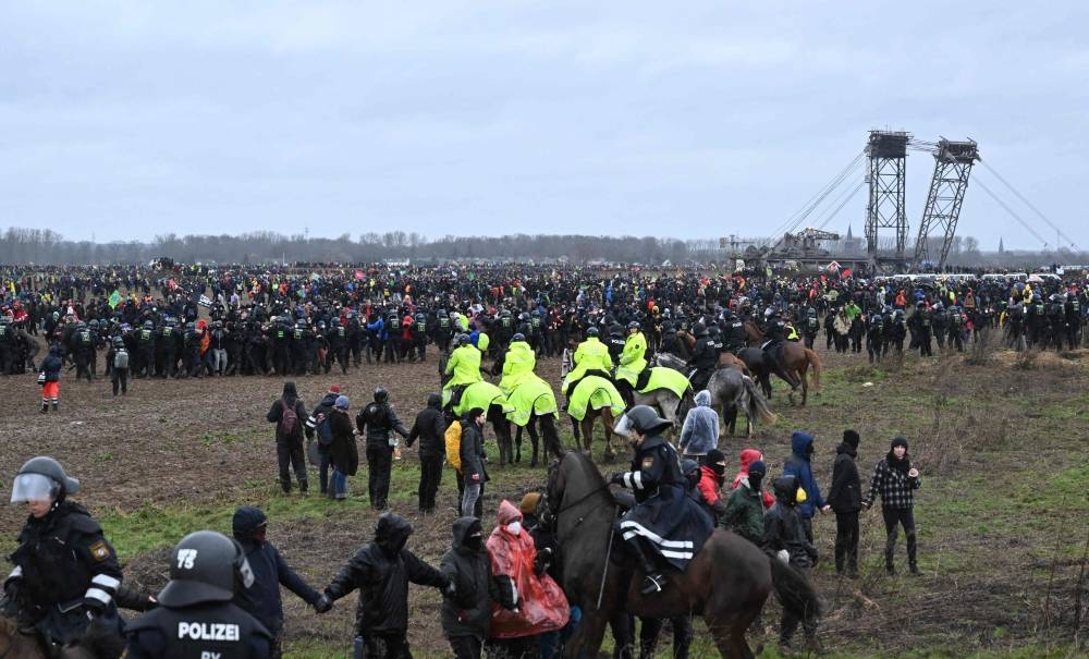 A general view shows mounted police during a large-scale protest to stop the demolition of the village Luetzerath to make way for an open-air coal mine extension on January 14, 2023. — AFP pic