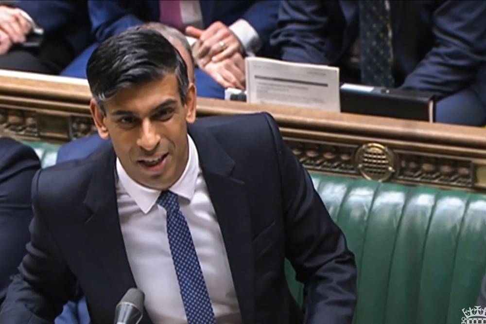 A video grab from footage broadcast by the UK Parliament's Parliamentary Recording Unit (PRU) shows Britain's Prime Minister Rishi Sunak gesturing and speaking, in the House of Commons, in London, on January 11, 2023. — PRU pic via AFP