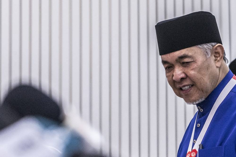 Umno president Datuk Seri Ahmad Zahid Hamidi (center) leaving the Merdeka Hall after finish his speech during the Umno's general assembly (PAU 2022) at World Trade Centre Kuala Lumpur January 14, 2023. — Picture by Hari Anggara