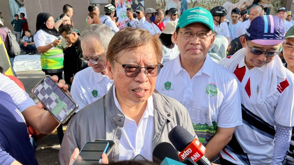 Abang Johari speaks to reporters when met at the Kuching Car Free Morning event at Padang Merdeka in Kuching today. — Picture by Roystein Emmor / Borneo Post