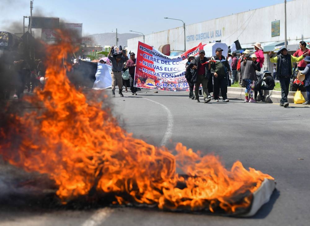 Demonstrators hold a blockade in the Pan-American highway at La Joya to demand the resignation of Peruvian President Dina Boluarte in Arequipa, Peru on January 12, 2023. — AFP pic