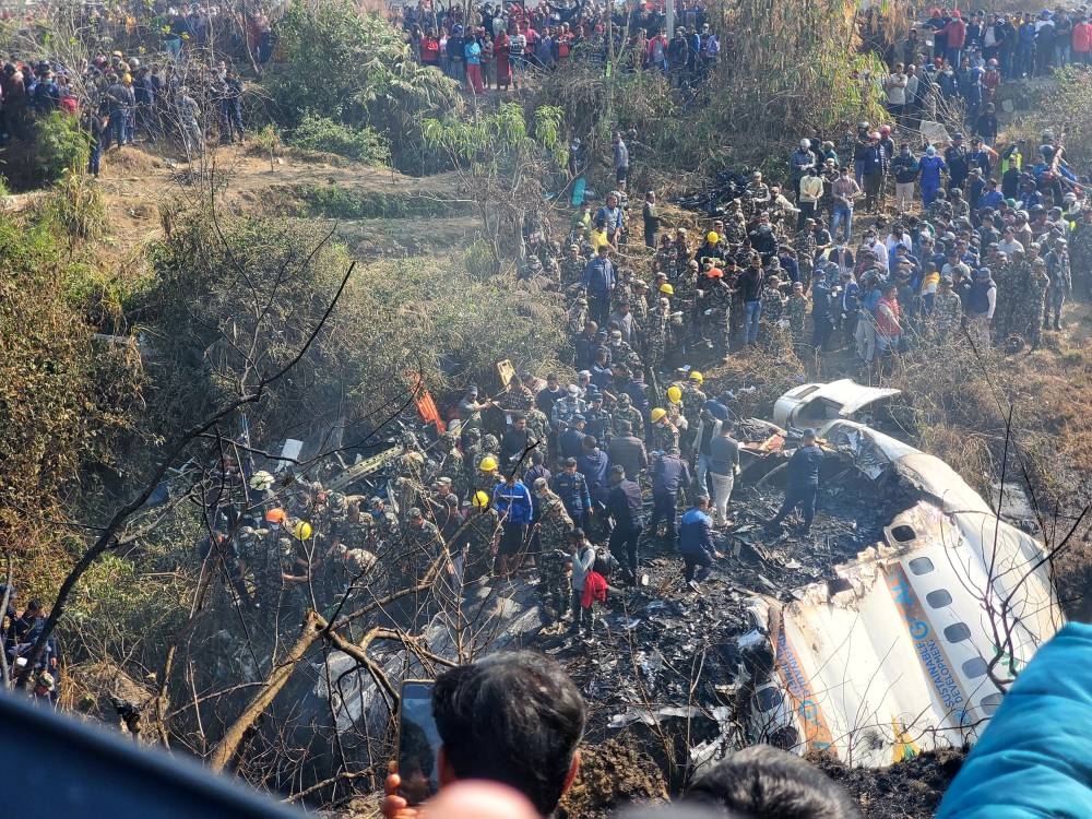 A general view of people gathered after the plane crash in Pokhara, Nepal January 15, 2023 in this picture obtained from social media. — Naresh Giri via Reuters pic