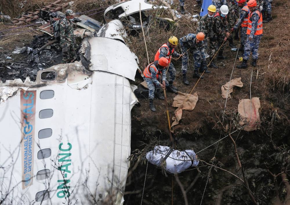 A rescue team recovers the body of a victim from the site of the plane crash of a Yeti Airlines operated aircraft, in Pokhara, Nepal January 16, 2023. — Reuters pic